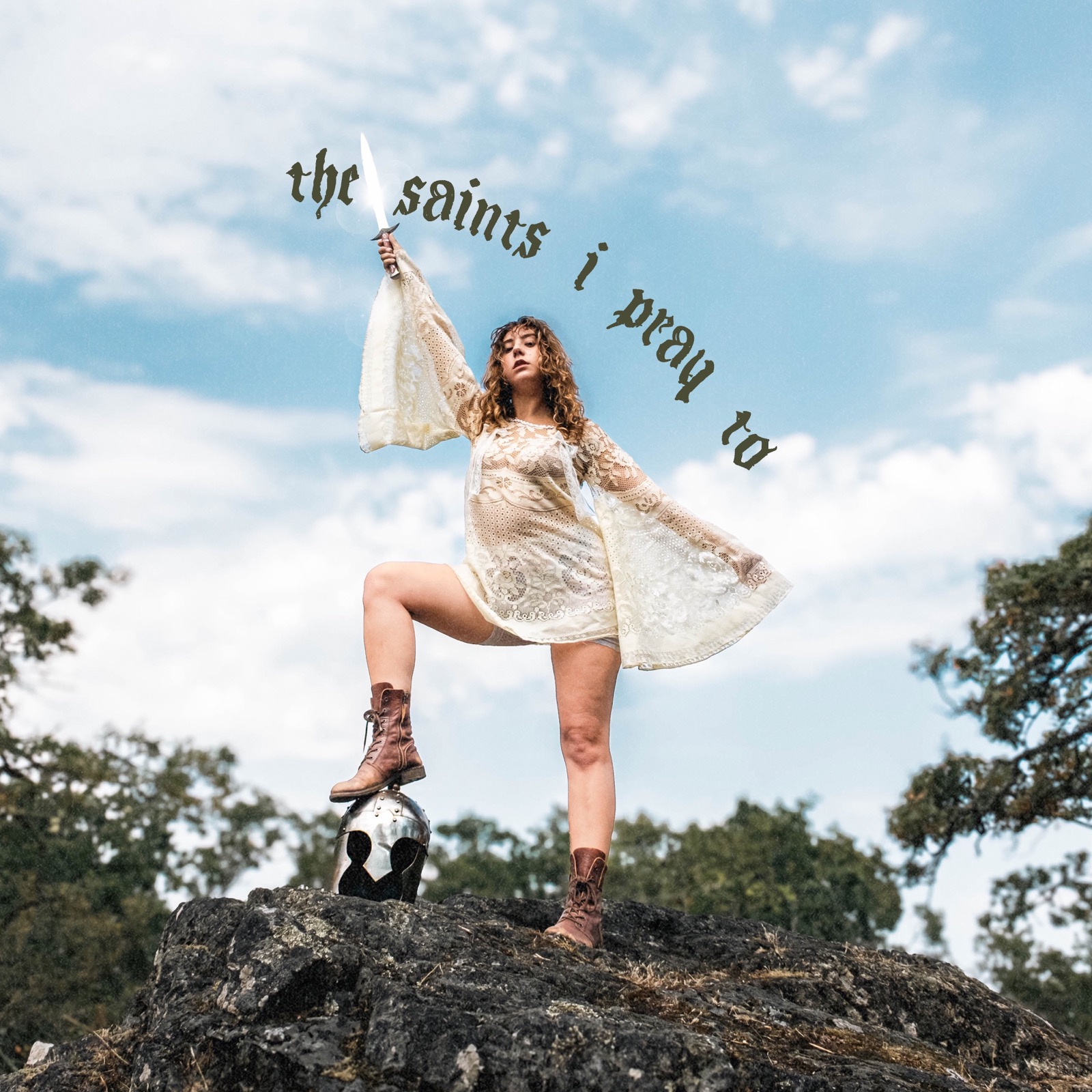 Single cover: Ella Slaughter on a rock raising a sword — the saints i pray to